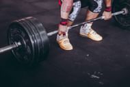 The barbell front raise targets the anterior and lateral deltoid muscles. (Photo via Pexels/Victor Freitas)